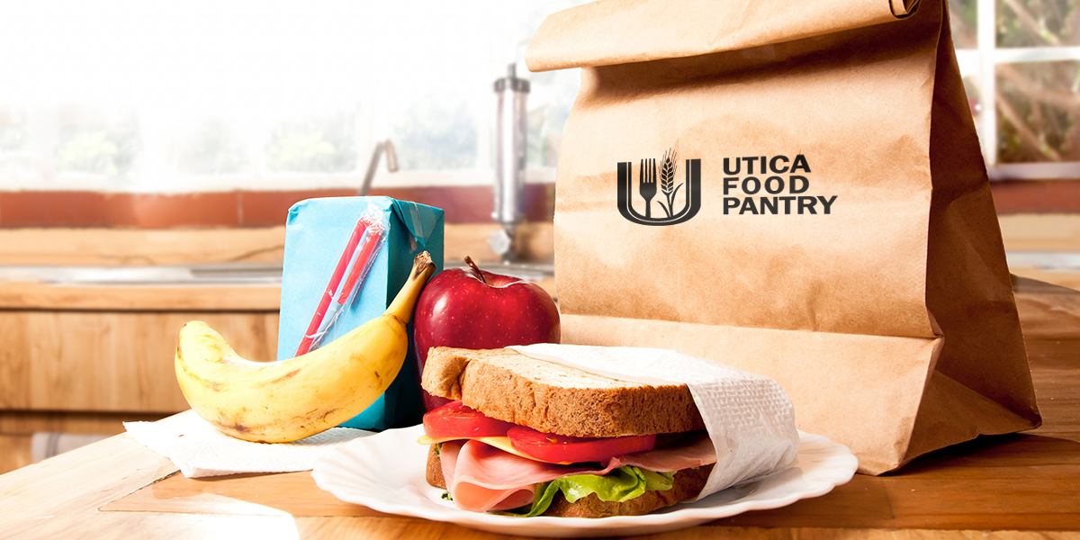 Sandwich, apple, and banana on table in front of brown paper bag